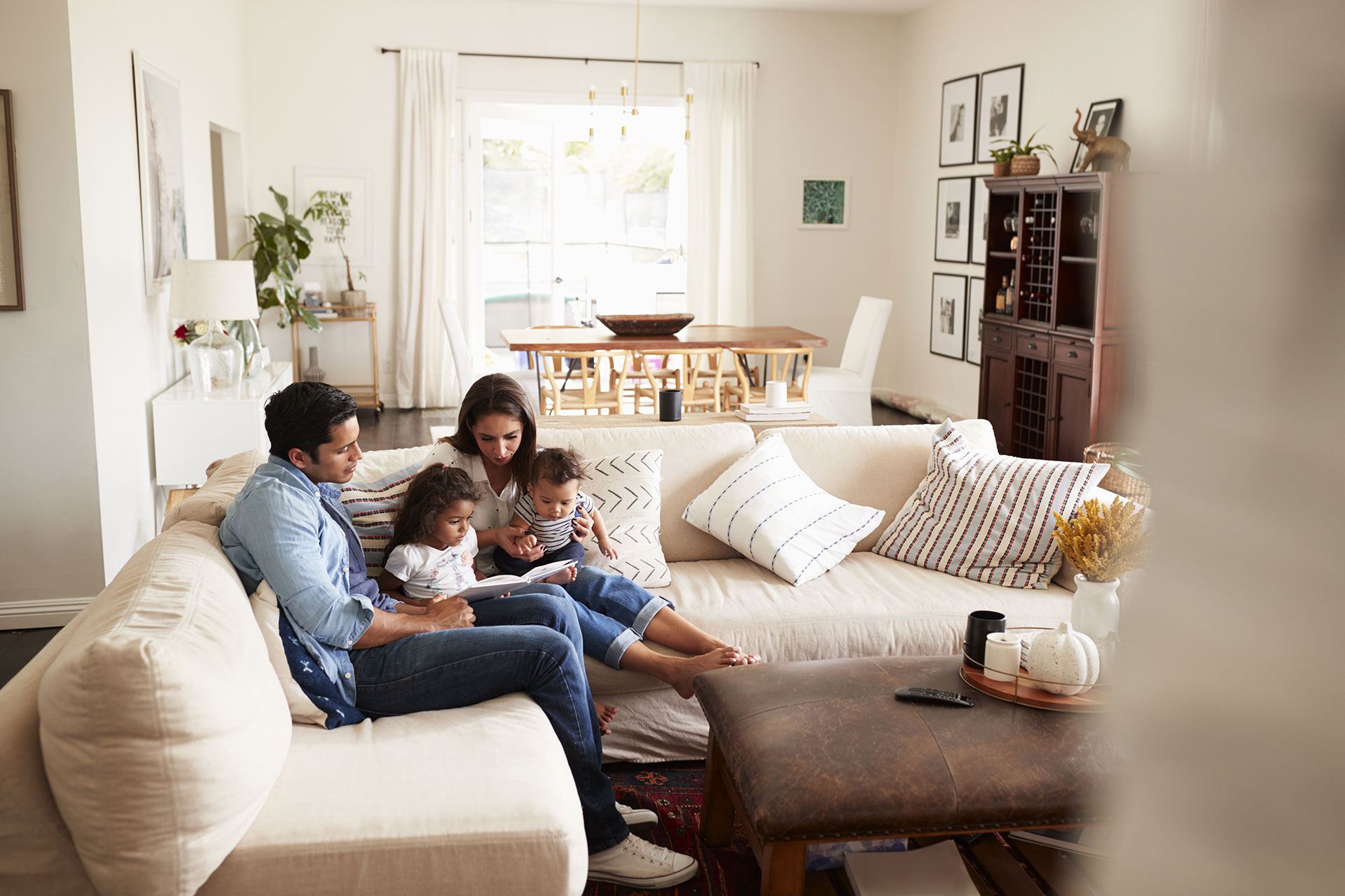 family reading a book on couch